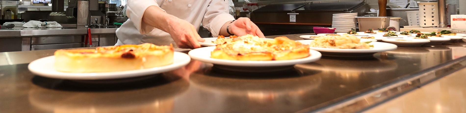 a chef plates dishes in a kitchen