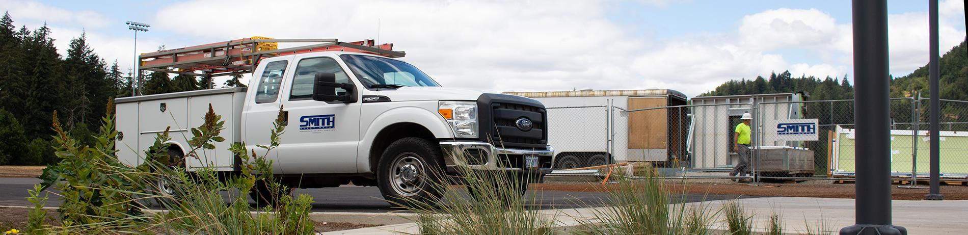 a truck and construction area with a rain garden in the foreground