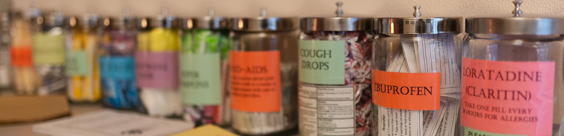 the Health Clinic's Self-Care station with brightly colored jars of things like cough drops, band-aids, and ibuprofen