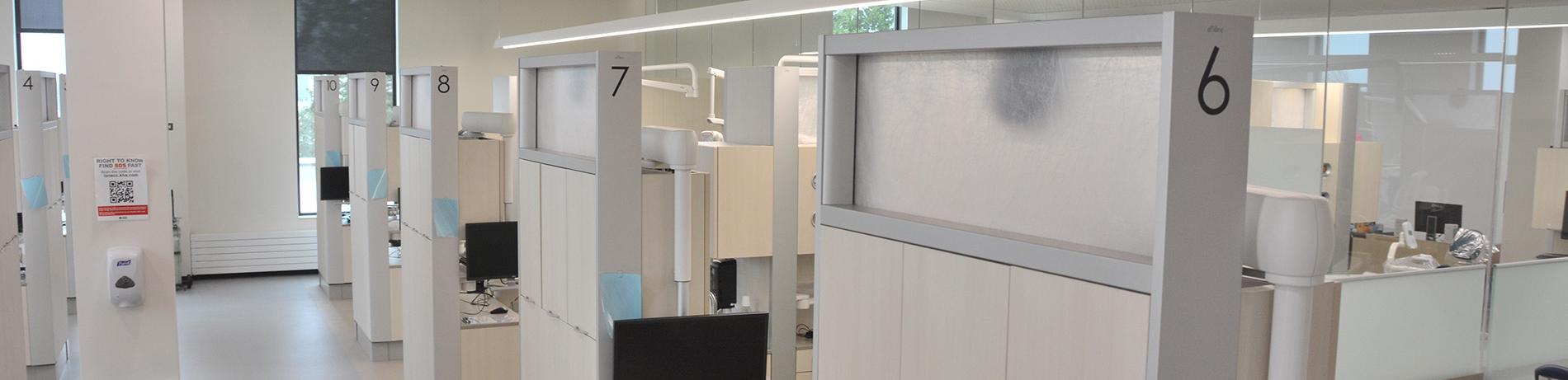 dental clinic cubicles in a clean, brightly lit room