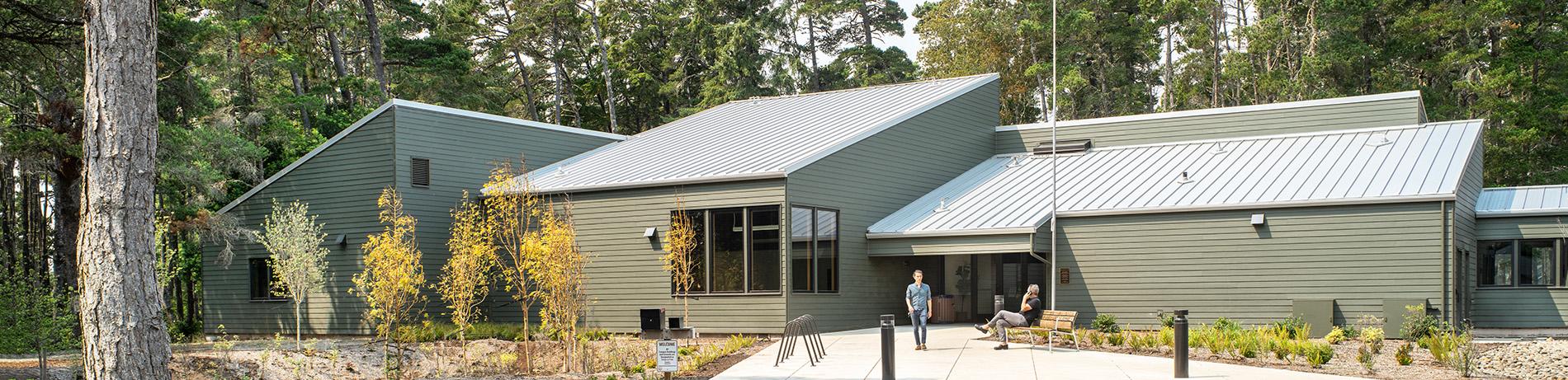 the exterior of the remodeled Florence Center, a sleek modern building nestled in a forest