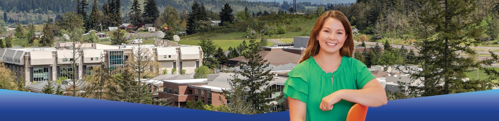 Cheyenne, a red haired student wearing a green shirt in the Lane Center building looking into the camera