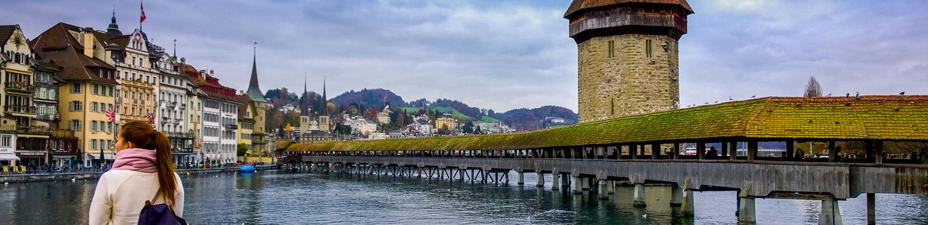 A global pathways student admires Chapel Bridge and Water Tower in Lucerne, Switzerland.