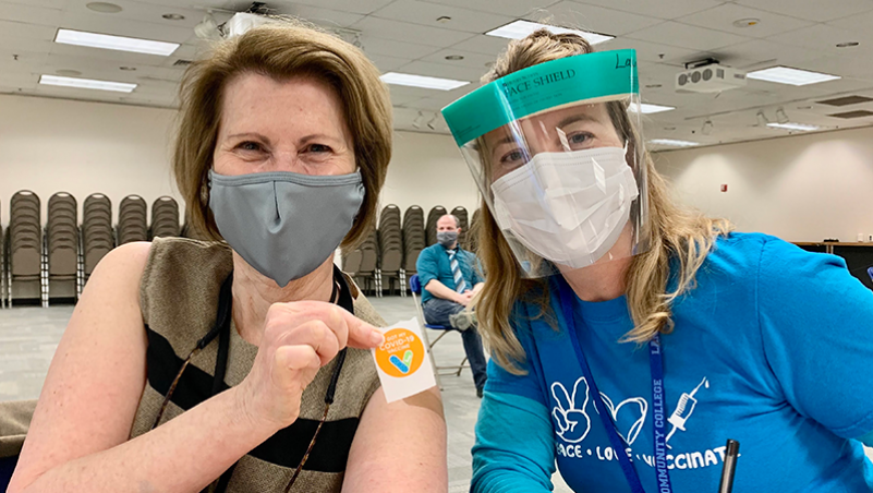 LCC President Margaret Hamilton celebrates her vaccine shot with Health Clinic Director Laura Greene 4-2021