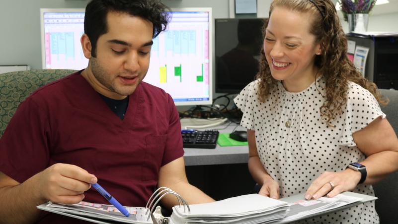 HIM student and faculty working on project