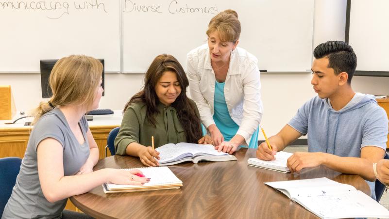 business instructor teaching students diversity and communications