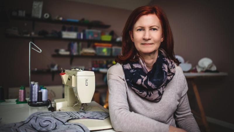 Artist Claire B. Jones sits in her workspace.