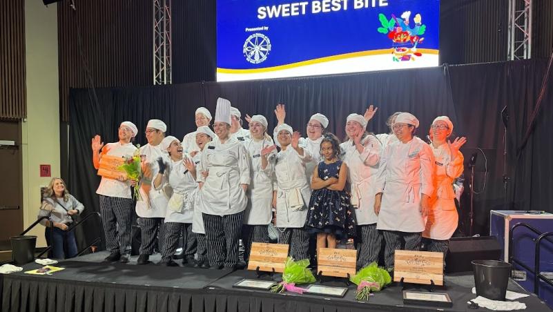 LCC Baking students on stage receiving Best Sweet Bite award at 2025 Chef's Night Out