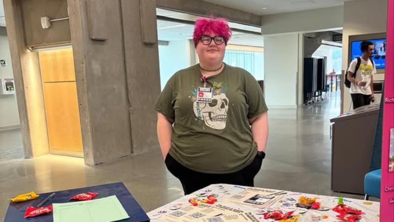 Kat Tabor, the editor of the Torch, recruits students at a club fair