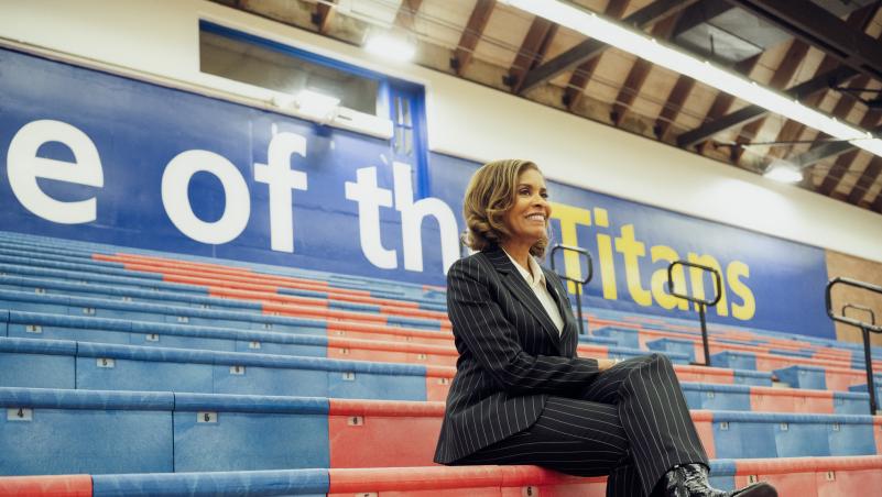 President Stephanie Bulger, in the gym, on bleachers.