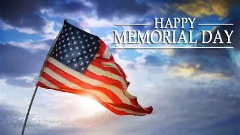 Happy Memorial Day, written on top of the sky, with the American Flag in the foreground