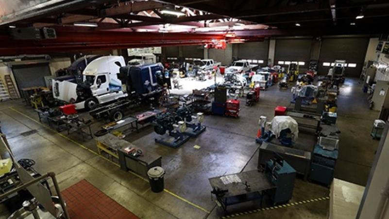 a large garage classroom on LCC campus filled with diesel trucks