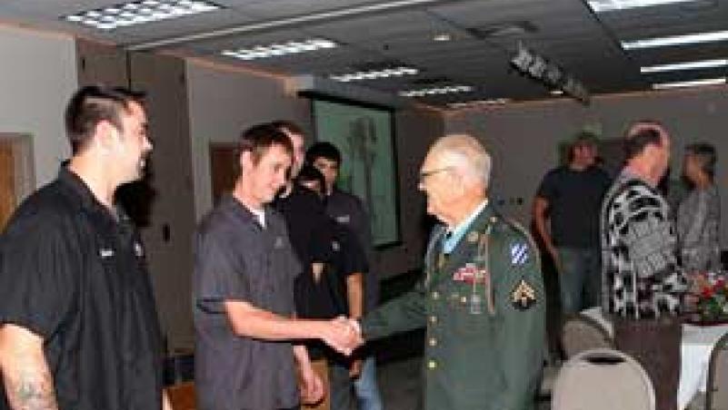image of Medal of Honor veteran Robert Maxwell greeting students at LCC in 2012