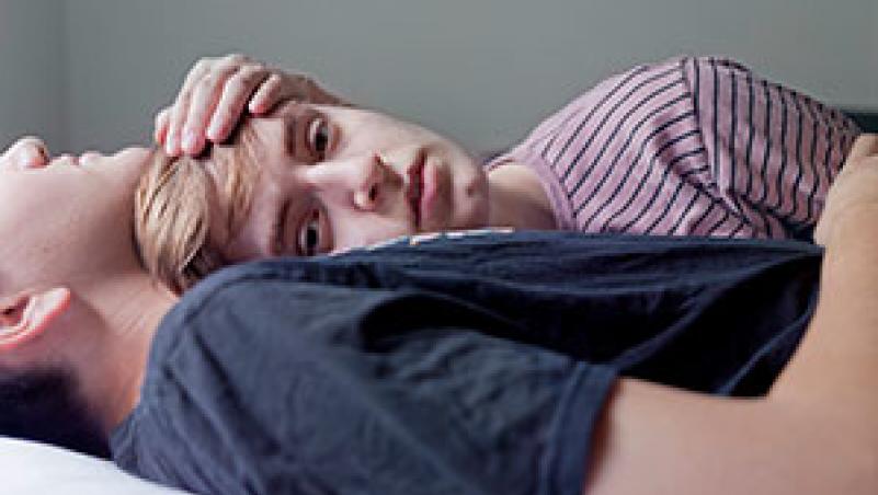 Photograph by Evan Baden image of young couple reclined in embrace