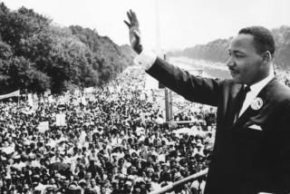 Dr. Martin Luther King, Jr. waves to supporters at a rally in Washington, DC