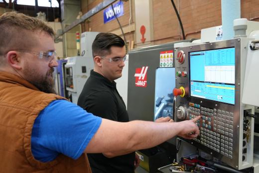 Instructor demonstrates machinery in CNC Lab at Lane Community College