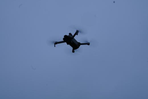 A drone is shone from underneath with the blue sky as a background.