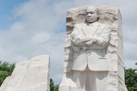 Photograph of the Martin Luther King, Jr. memorial monument in Washington, DC.  Dr. King is carved into stone, standing with his arms crossed.