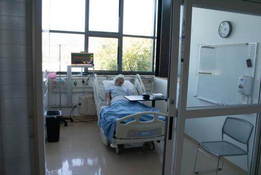 Simulation hospital room with a mannequin in bed, medical monitor, and equipment by the window.
