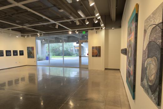 The brightly lit LCC Art gallery with abstract, 2D art on the walls