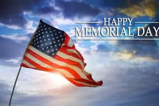 Happy Memorial Day, written on top of the sky, with the American Flag in the foreground