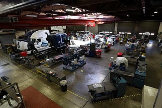 a large garage classroom on LCC campus filled with diesel trucks