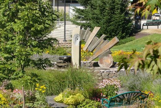 A fountain between buildings 1 and 4, with foliage around it