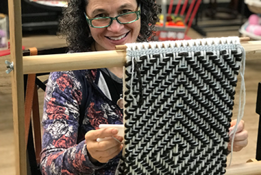 Susan Pavel weaving a wallhanging