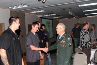 image of Medal of Honor veteran Robert Maxwell greeting students at LCC in 2012