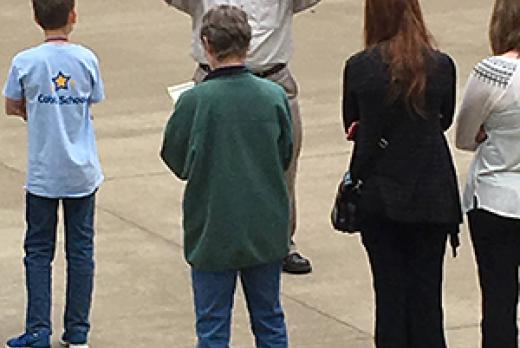 image of Dr. Paul Ruscher with several middle and high school students