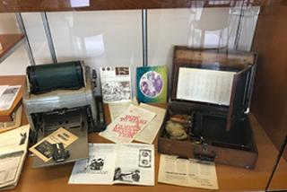 image of display with copier, typewriter and printed materials