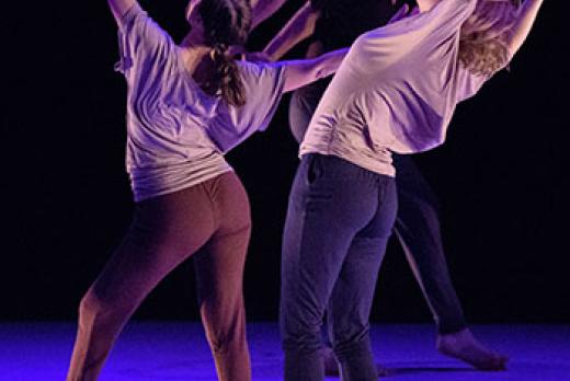 image of three Lane dancers in movement, on stage