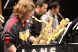 image of three students playing saxophone