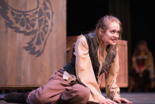 image of student actor Lydia Reynolds, sitting on stage