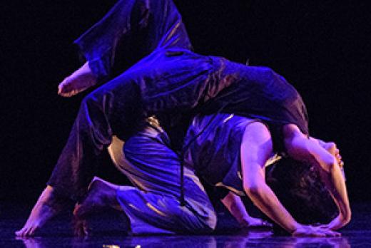 two dancers in pose, on stage