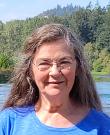 Headshot of Margaret Robertson in front of a lake