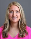 dental assisting instructor Audrey Ferguson smiling and wearing pink scrubs