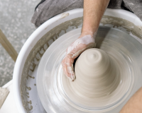 person using a pottery wheel