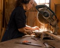 Carpenter cutting a board for a construction project