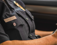 officer sitting in car writing notes