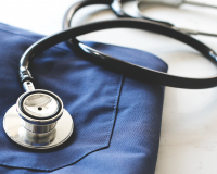 stethoscope on table with medical coat