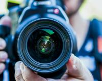 a multimedia student using a camera for photography class