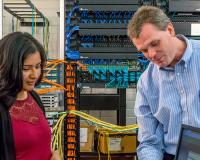 two people looking at a computer