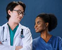 A student in the LPN to RN program smiles with a doctor