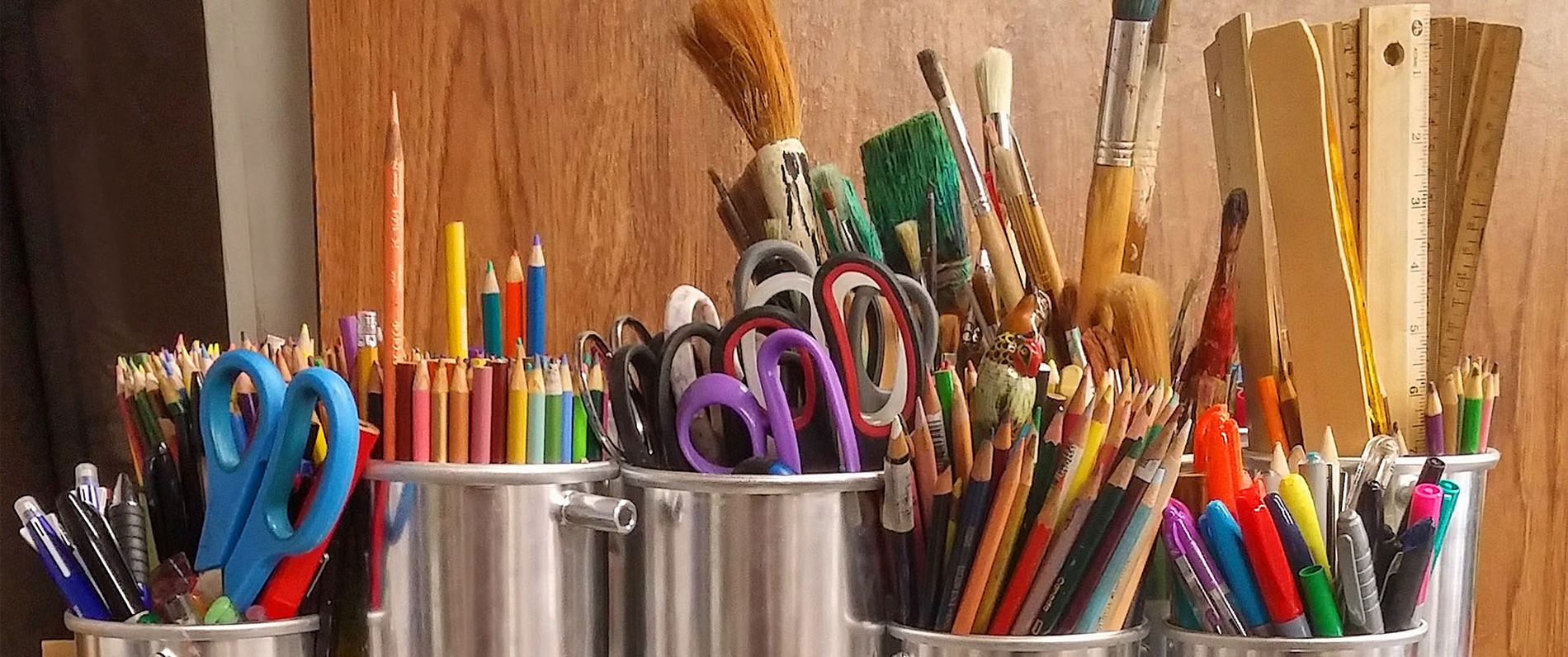 artists work table with brushes, pencils and other tools ready to go for project