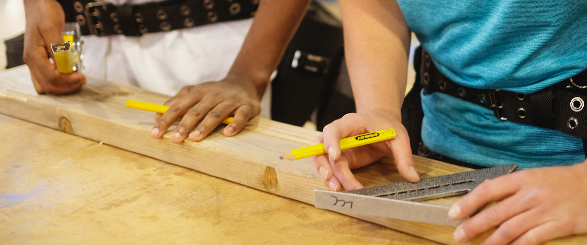 carpenter measuring and cutting a board