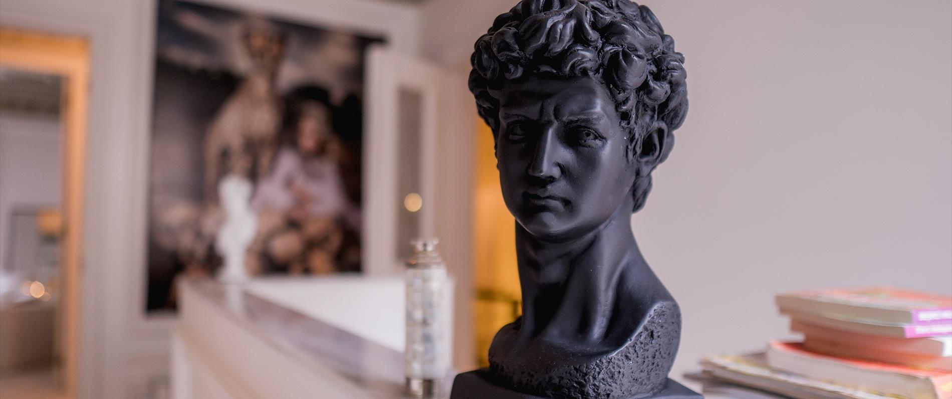 sculpture of a head on a desk