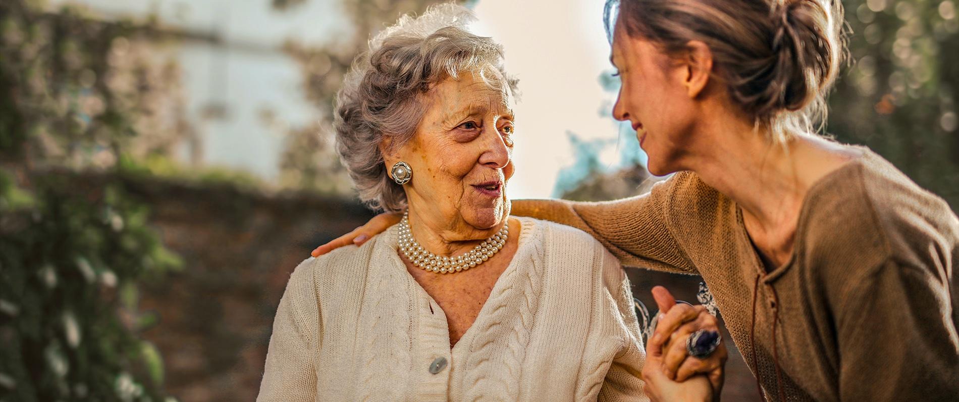 A woman greeting and hugging another woman
