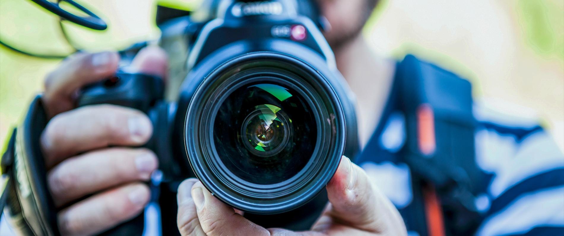 a multimedia student using a camera for photography class