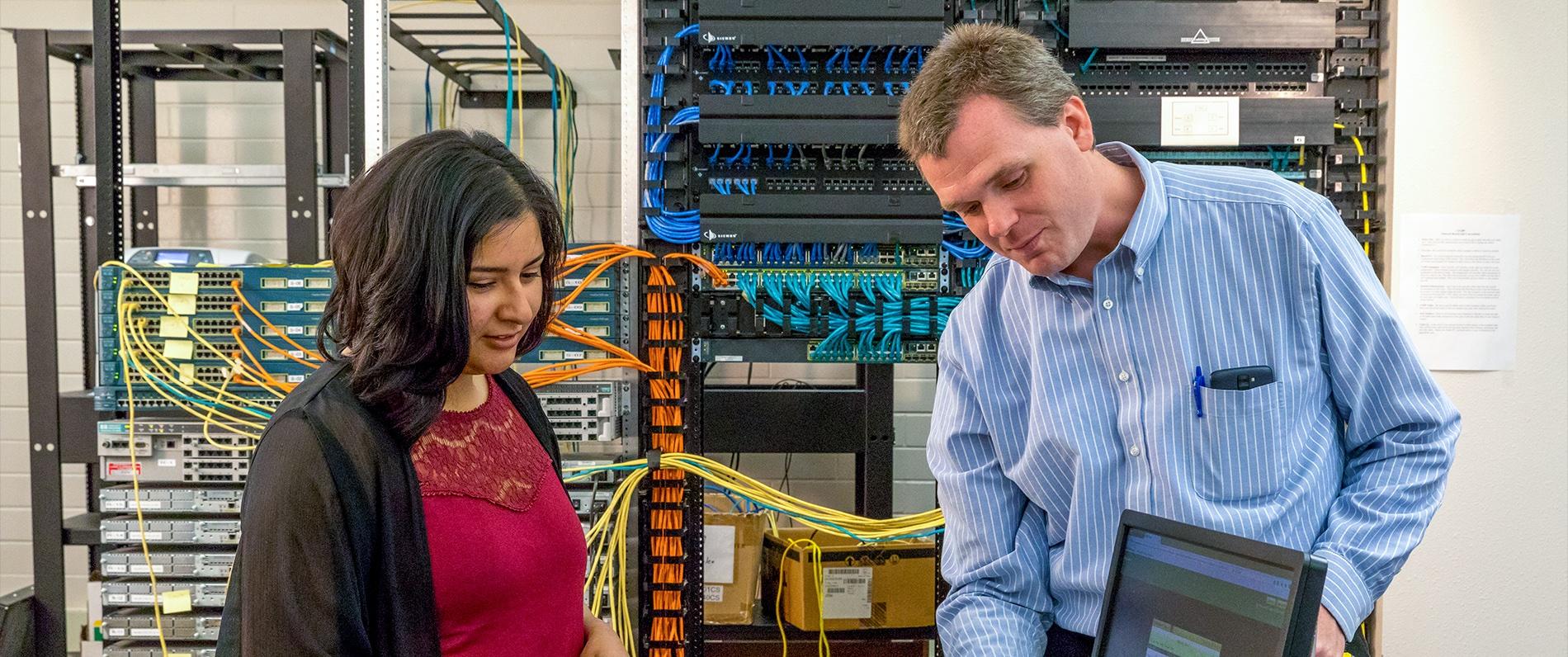 two people looking at a computer